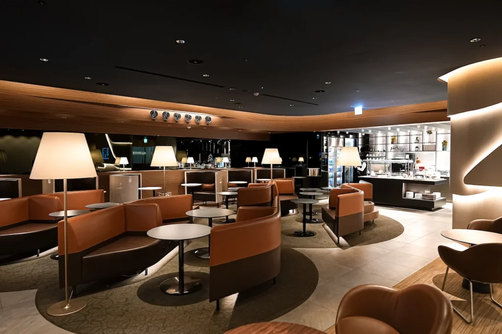 Starlux Airlines Galactica Lounge in Taipei featuring brown leather booths, small tables, and lamps