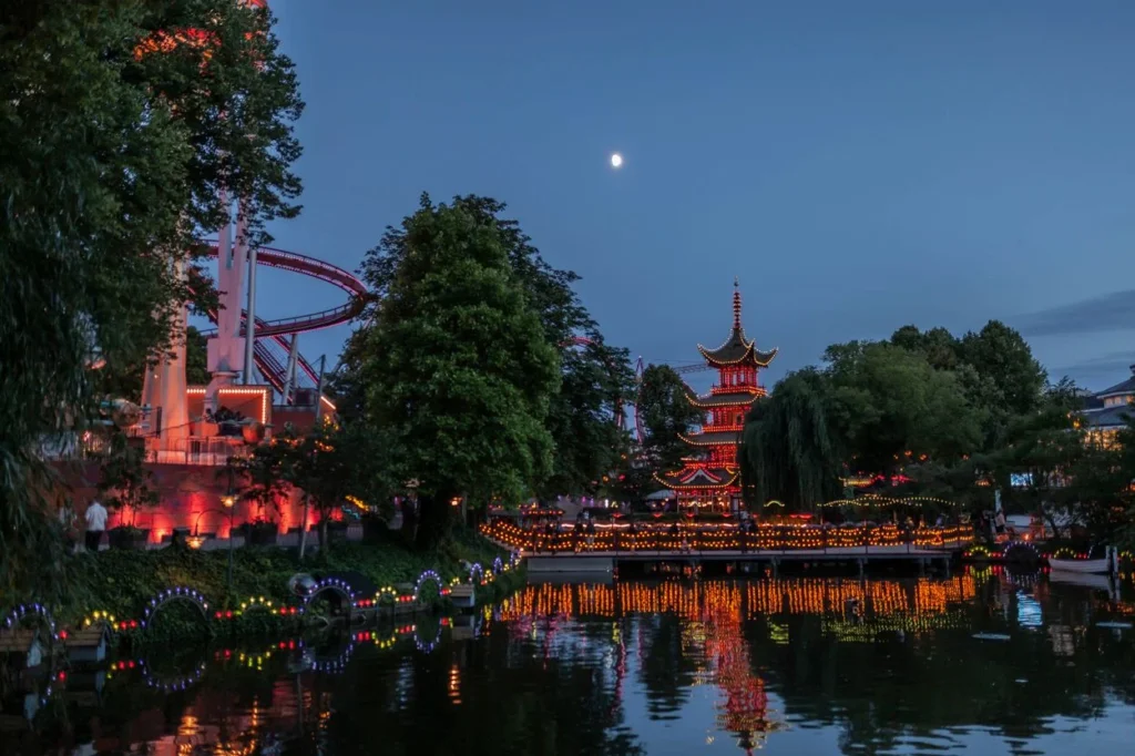 The illuminated Chinese Pagoda reflecting in the lake at Tivoli Gardens in Copenhagen