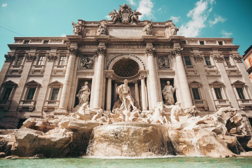 The stone statues and flowing water of the Trevi Fountain in Rome