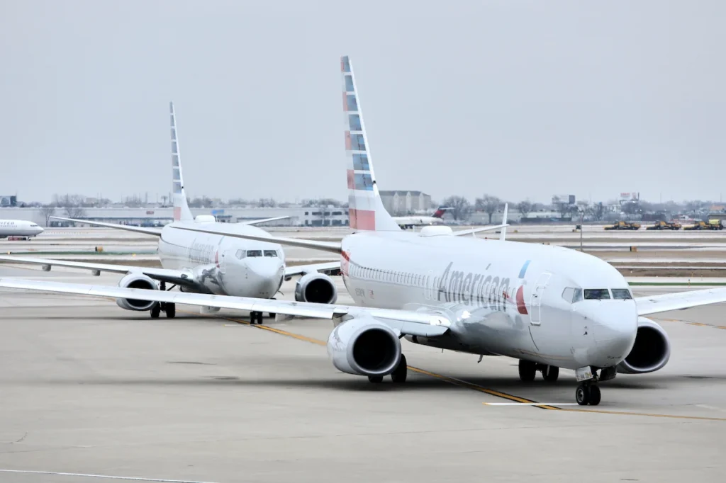 Two American Airlines passenger airplanes taxied on an airport tarmac