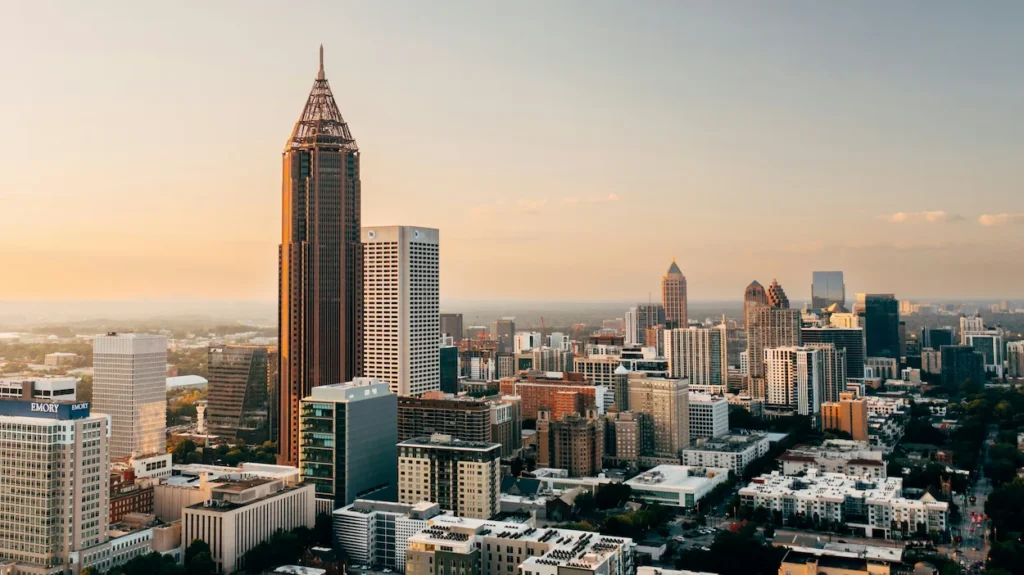 Aerial view of the Atlanta skyline at sunset featuring the Bank of America Plaza