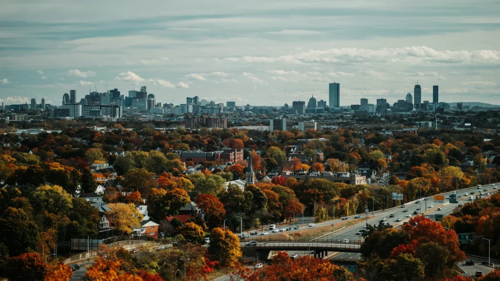 Boston skyline framed by vibrant autumn foliage