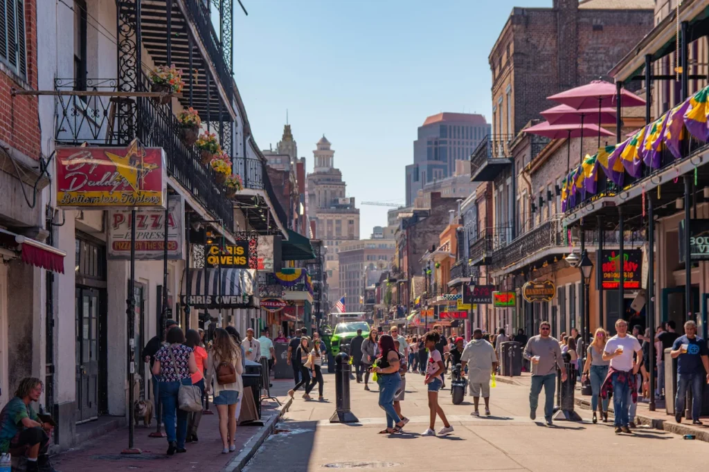 Bourbon Street in the French Quarter with historic balconies and neon signs