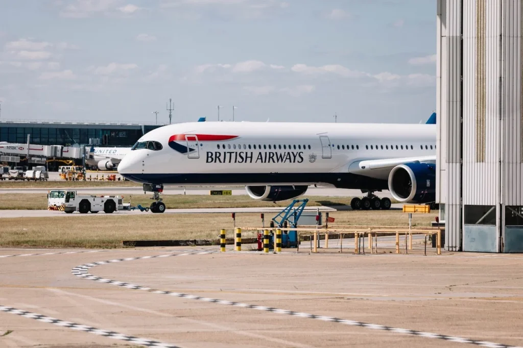 A British Airways airplane parked near an airport hangar