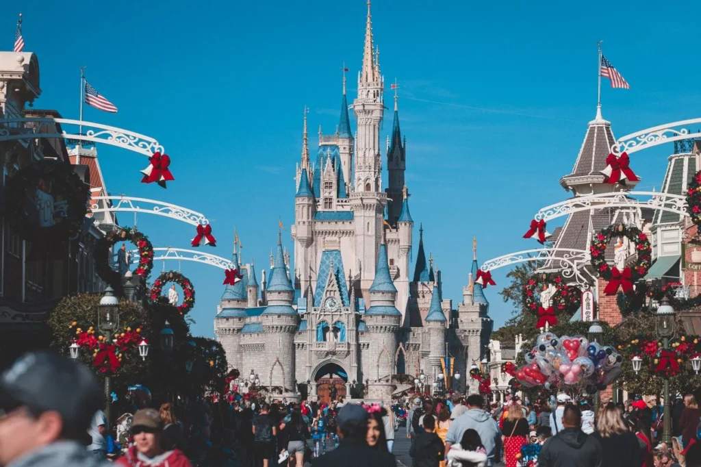 Cinderella Castle at Magic Kingdom decorated with Christmas wreaths and red bows