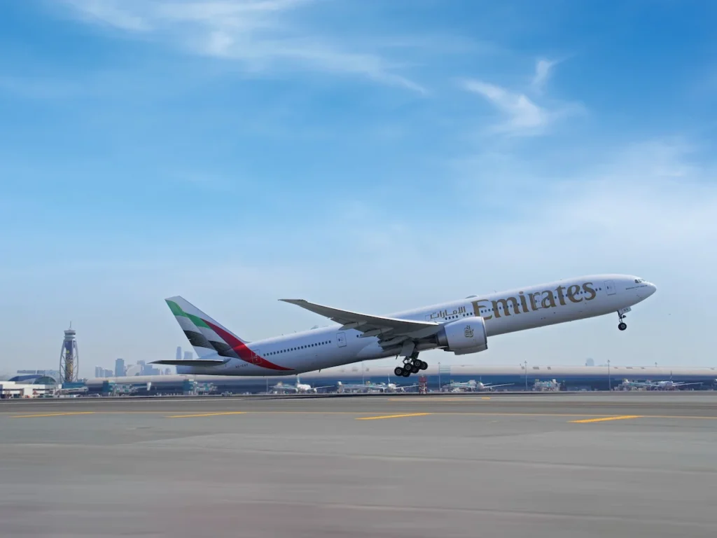 Emirates Boeing passenger plane taking off from an airport runway