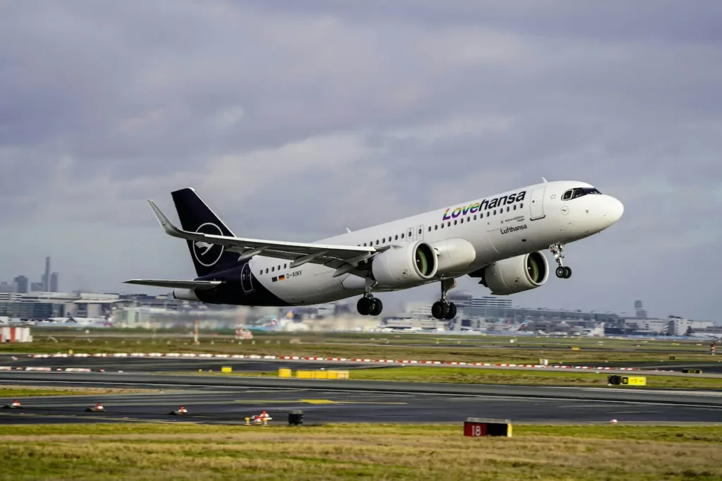 Lufthansa Airbus passenger plane with "Lovehansa" text taking off from an airport runway
