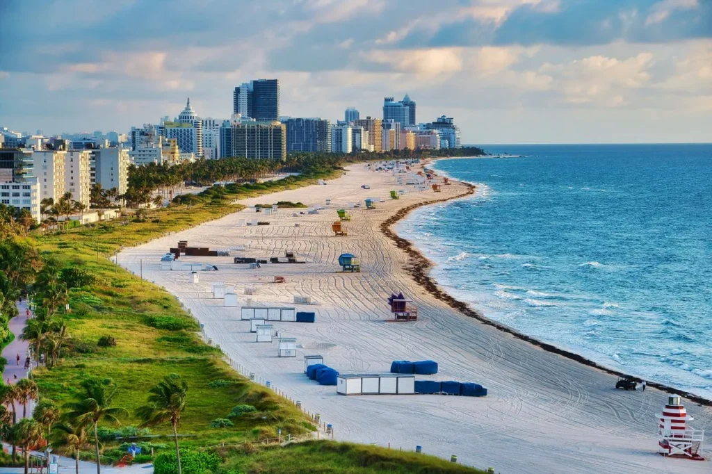 An aerial view of the South Beach coastline and high-rise hotel skyline in Miami Beach, Florida