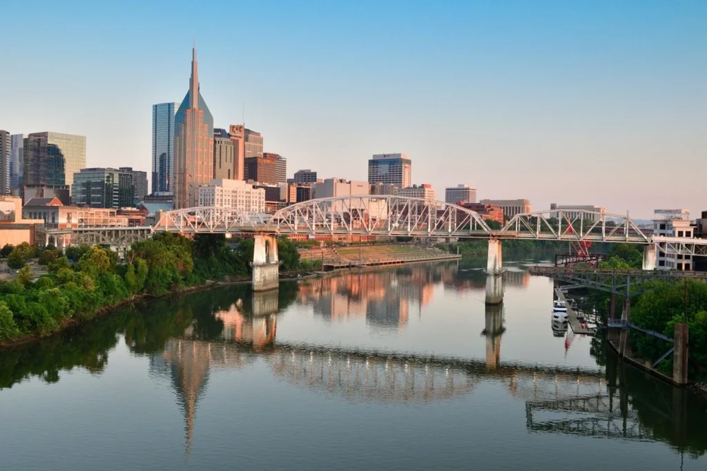Nashville skyline and the John Seigenthaler Pedestrian Bridge reflecting across the Cumberland River