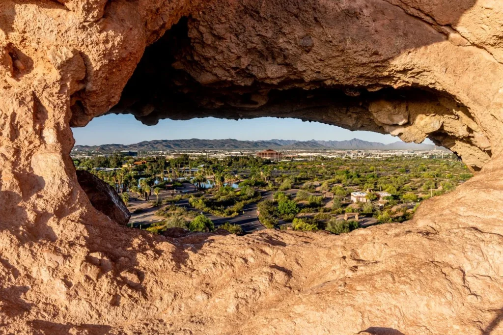 Desert valley landscape viewed through the natural opening of Hole-in-the-Rock at Papago Park