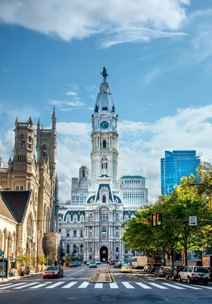Street-level view looking down a busy road toward Philadelphia City Hall in Pennsylvania