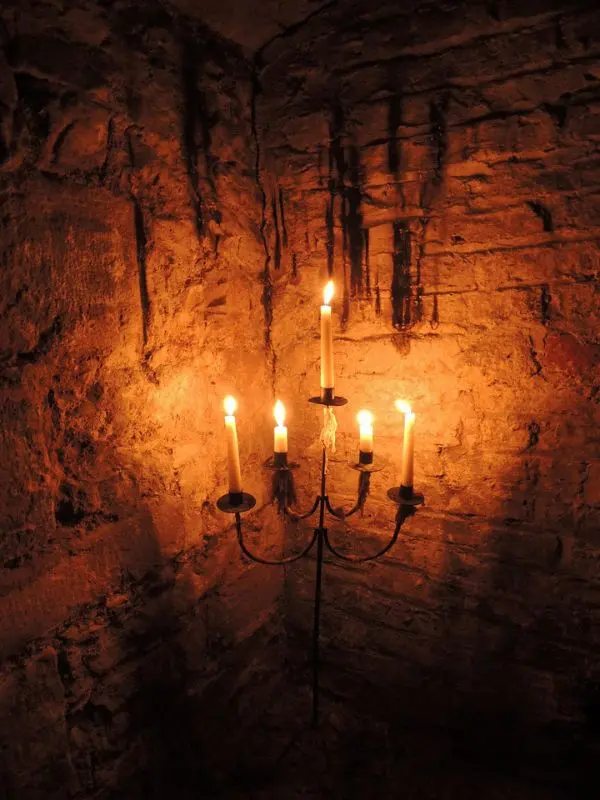 Candles glowing in a stone cellar on a Mercat Tour.