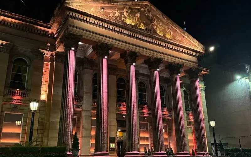 The Dome lit with pink lights at night.