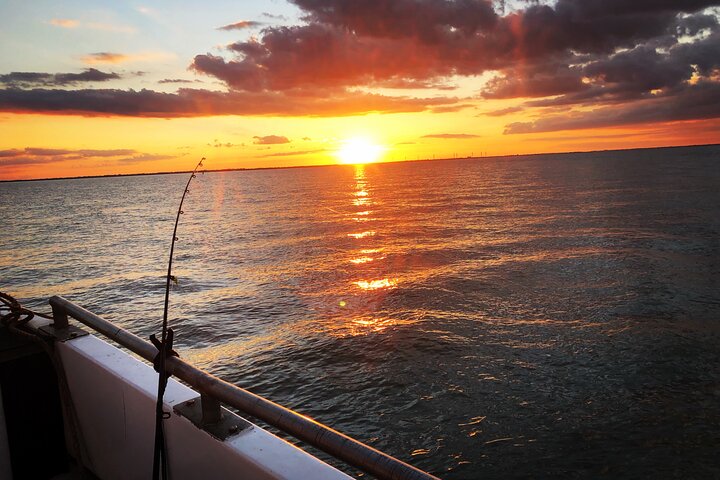Sunset view over the water from a boat on Dawn Tide Charters.