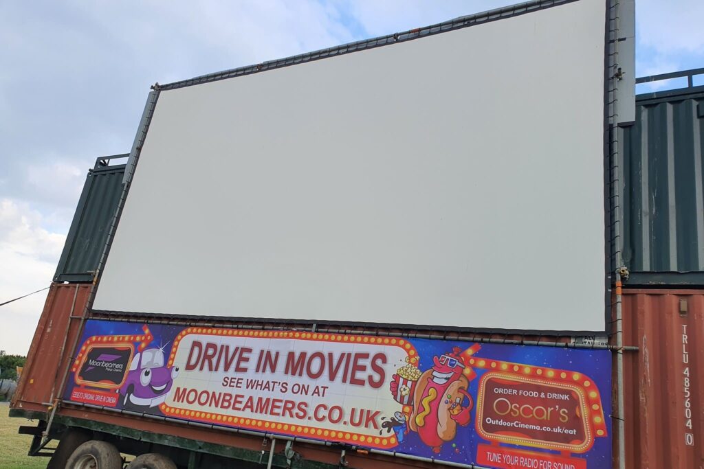 Moonbeamers popup cinema drive-in movie screen with banner advertising moonbeamers.