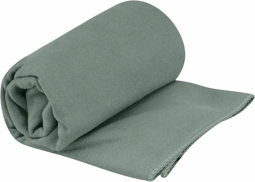Sage green Sea to Summit Drylite microfiber towel, partially rolled up