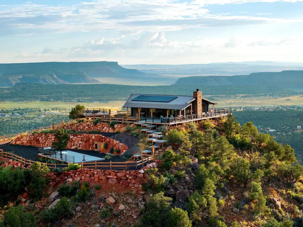 Elevate your fall getaway at this stunning cabin, perched on a rocky bluff with breathtaking views at one of the best fall foliage Airbnbs in the US