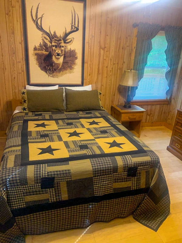 Rustic charm meets cozy comfort in this cabin bedroom, perfect for relaxing after a day of exploring!
