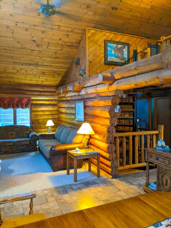 Super cozy log cabin living room—perfect spot to chill and relax after a day of adventures