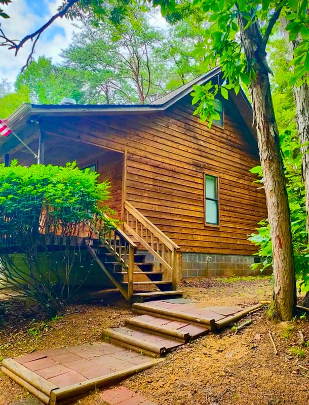 Enjoy the stunning mountain views from the spacious yard of this cozy Pigeon Forge cabin, perfect for your fall escape