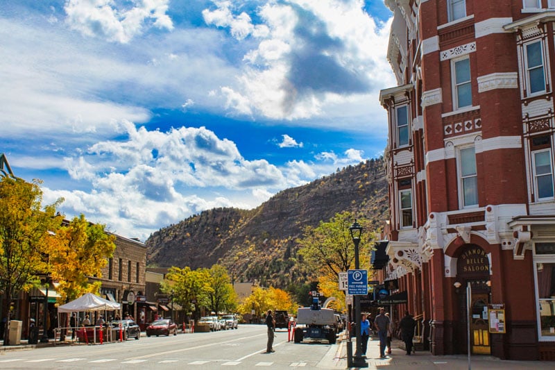 Durango, CO, with historic buildings against a mountain backdrop.