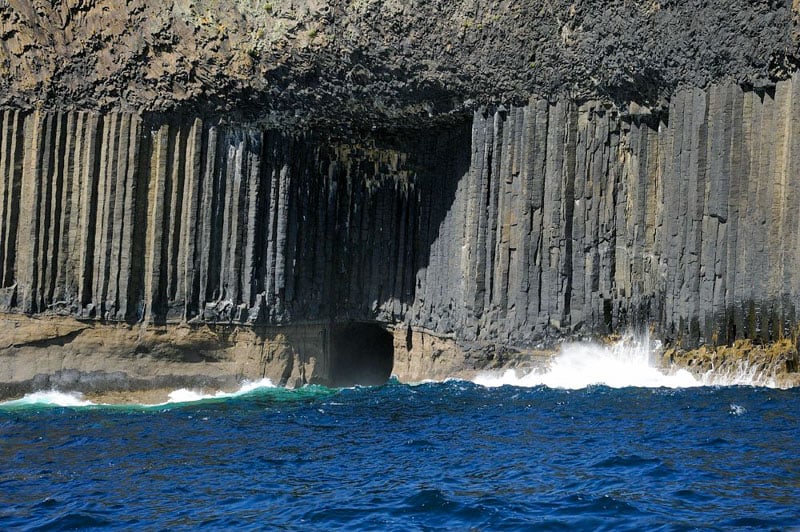 Fingal's Cave in Scotland features hexagonal basalt columns shaped by the sea.