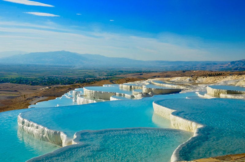 Pamukkale's thermal pools in Turkey, with white terraces and turquoise water.