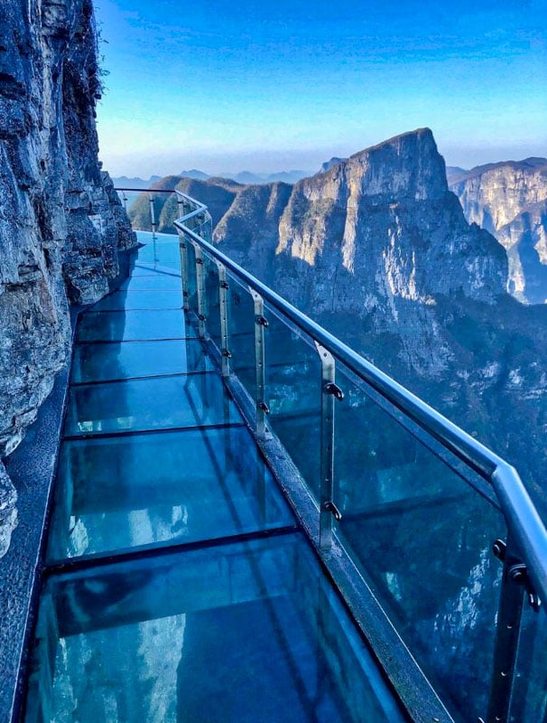 China's Tianmen Mountain Skywalk, a glass walkway 4,700 feet up, wraps around sheer cliffs, offering nerve-wracking views.