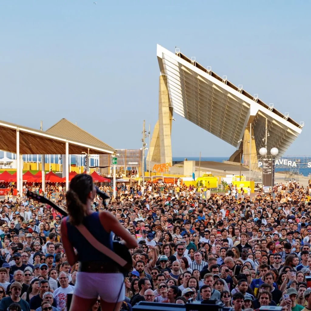 A musician performs on stage before a large outdoor crowd at Primavera Sound in Barcelona