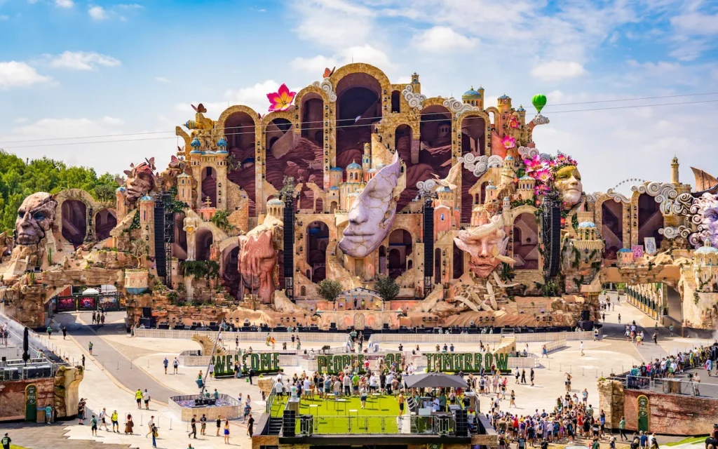 The massive Tomorrowland mainstage decorated with giant sculpted faces and castle structures