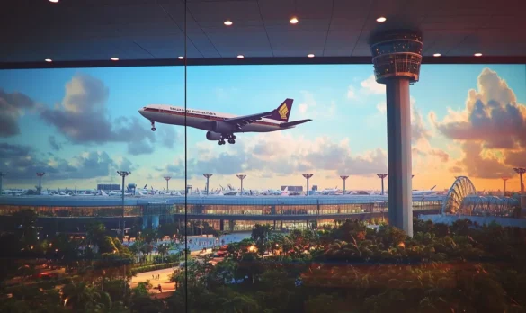 A plane leaving Singapore Airport at dusk.