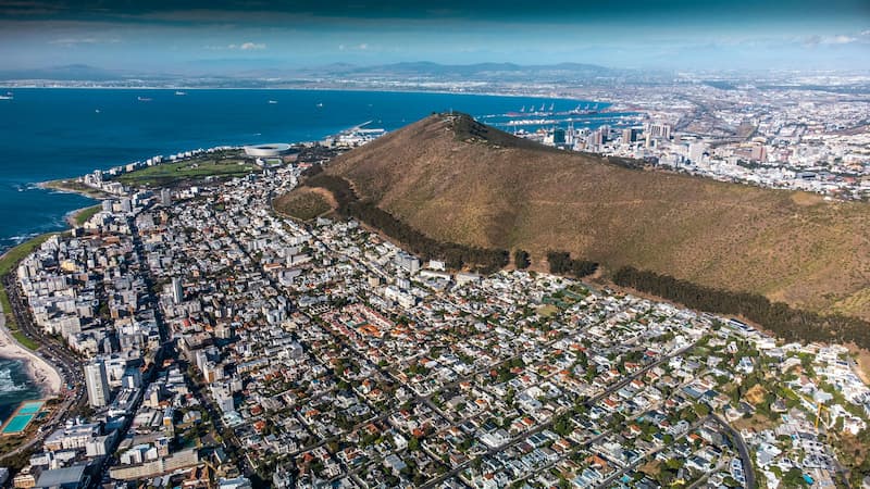 Aerial view of Cape Town, South Africa, showcasing Table Mountain, the city, and the coastline.