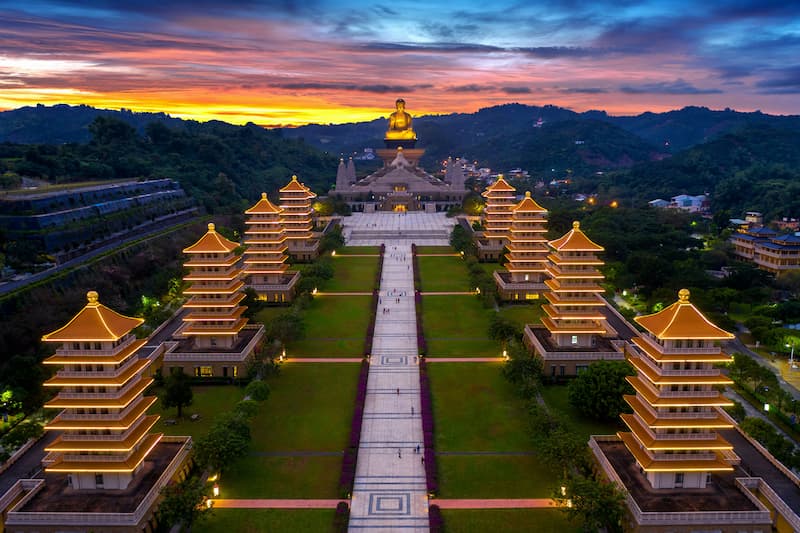 The Dragon and Tiger Pagodas at Lotus Pond in Kaohsiung, Taiwan, under a cloudy sky.