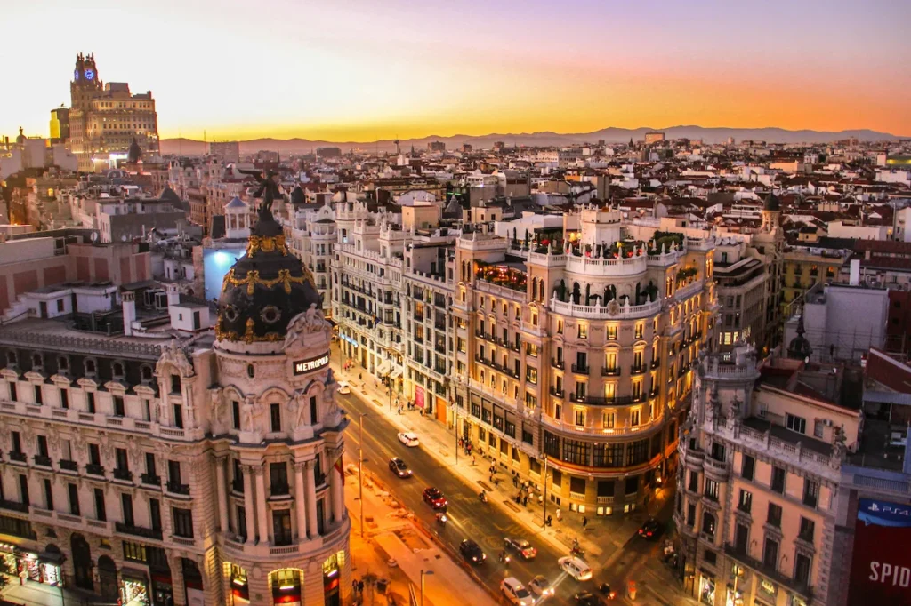 Metropolis Building at the intersection of Gran Vía street in Madrid during sunset