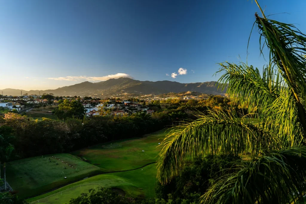 Panoramic view of the San José city valley tucked inside lush green mountains in Costa Rica