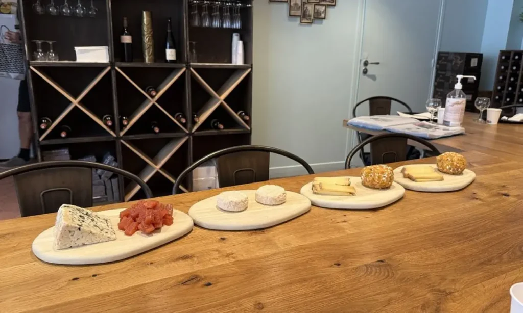 A row of wooden boards displaying different cheeses during a gourmet food tour in Montmartre or near Notre Dame.