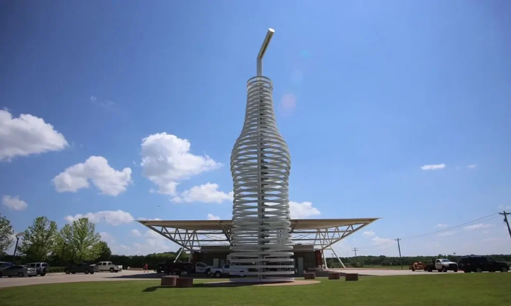 Large soda bottle sculpture in front of Pops 66 Soda Ranch.