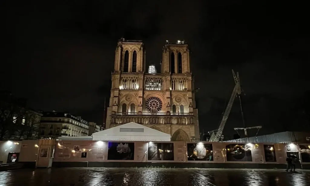 The front of Notre-Dame Cathedral in Paris lit up at night.