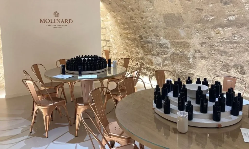 Tables with perfume bottles set up for a fragrance workshop at Molinard Parfums in Paris.