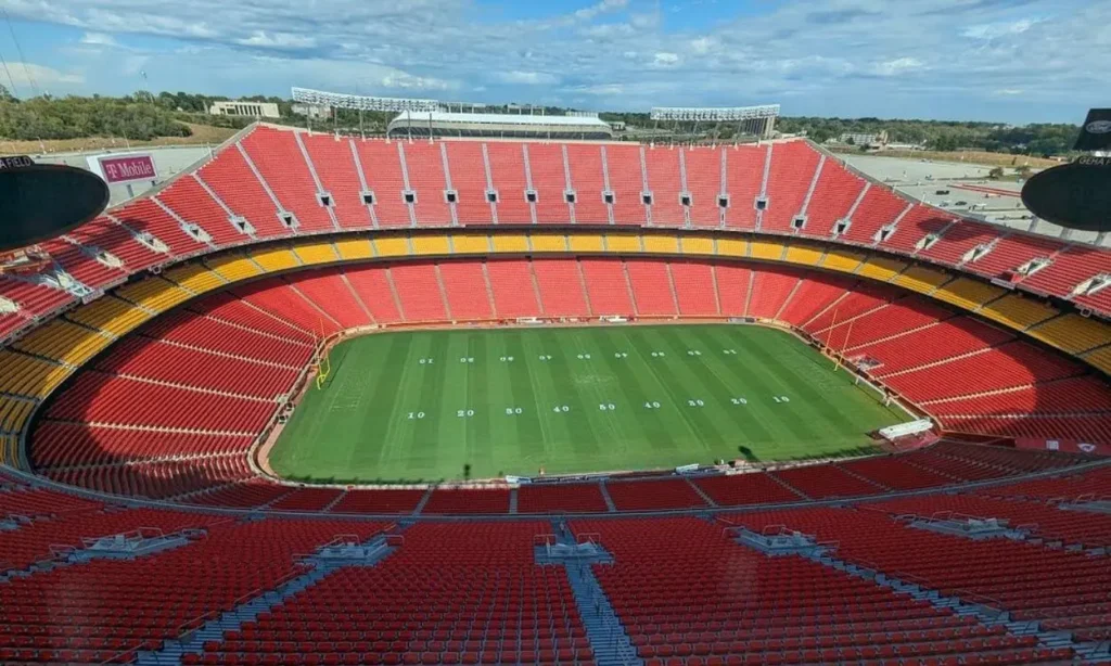 A wide view of GEHA Field with red and yellow seats around the field.