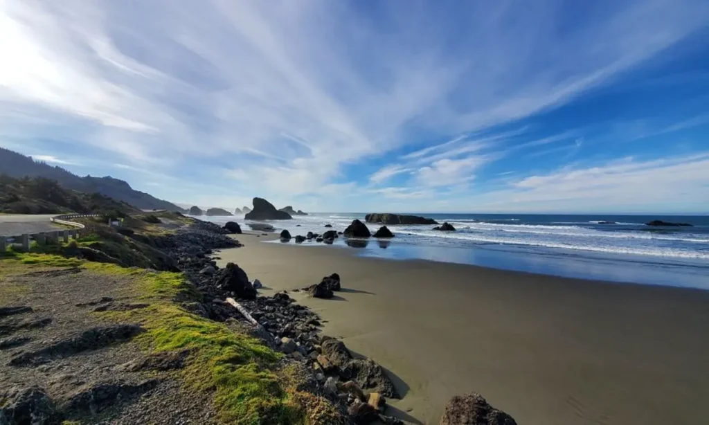 Scenic coastal view along the Oregon Coast Highway with rocks and waves.