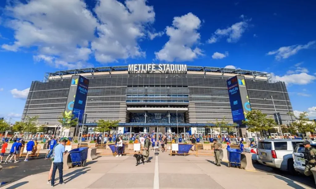 MetLife Stadium front view with people gathered outside.