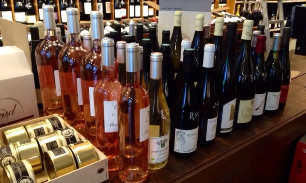 A display of rosé, white, and red wine bottles at a wine bar in Belleville.