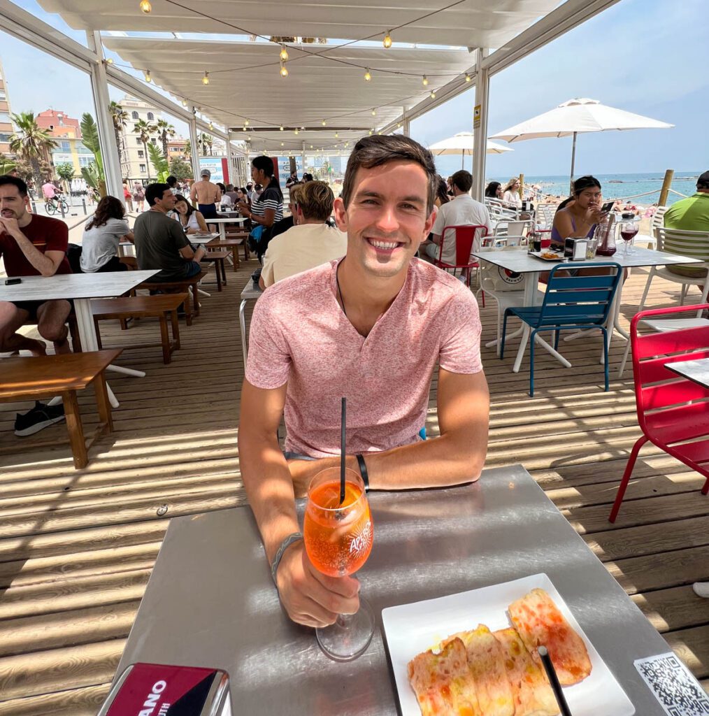 My photo of me enjoying an aperol spritz and pan con tomate at the beach in Barcelona