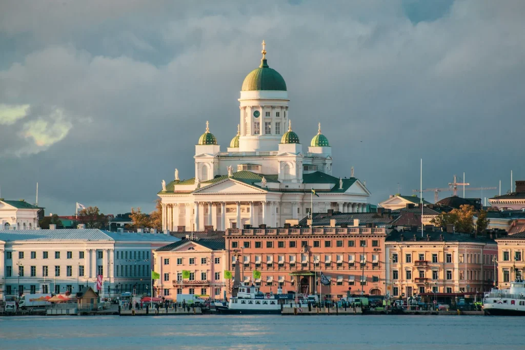 The white Helsinki Cathedral rising above the historic harbor waterfront buildings