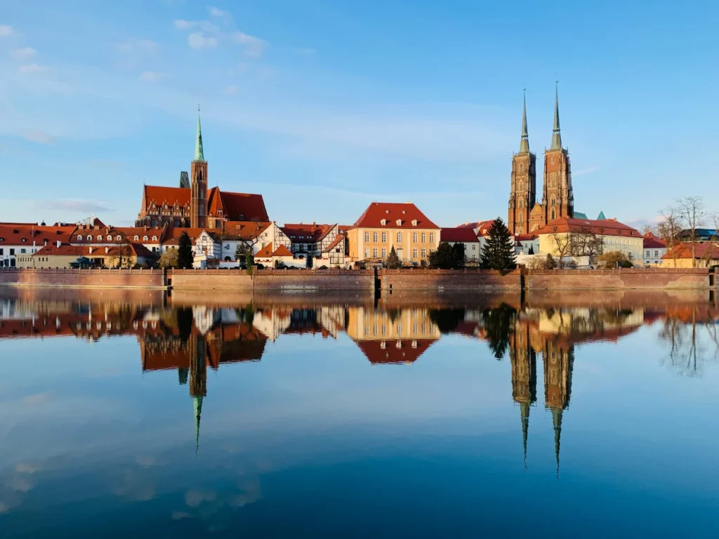 Historic churches of Ostrów Tumski reflecting perfectly in the Oder River