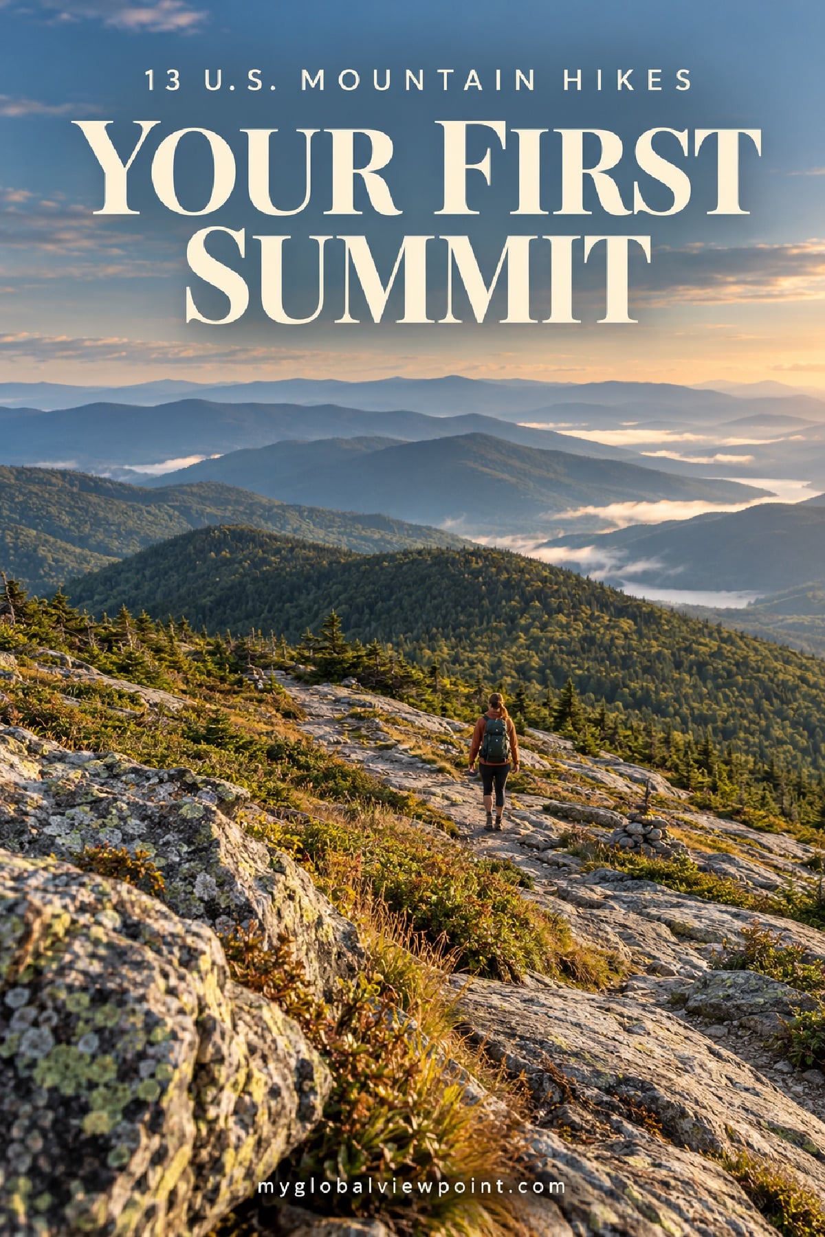 A hiker walking an open rock ledge toward a forested summit ridge, with mist settling in the valleys at sunrise