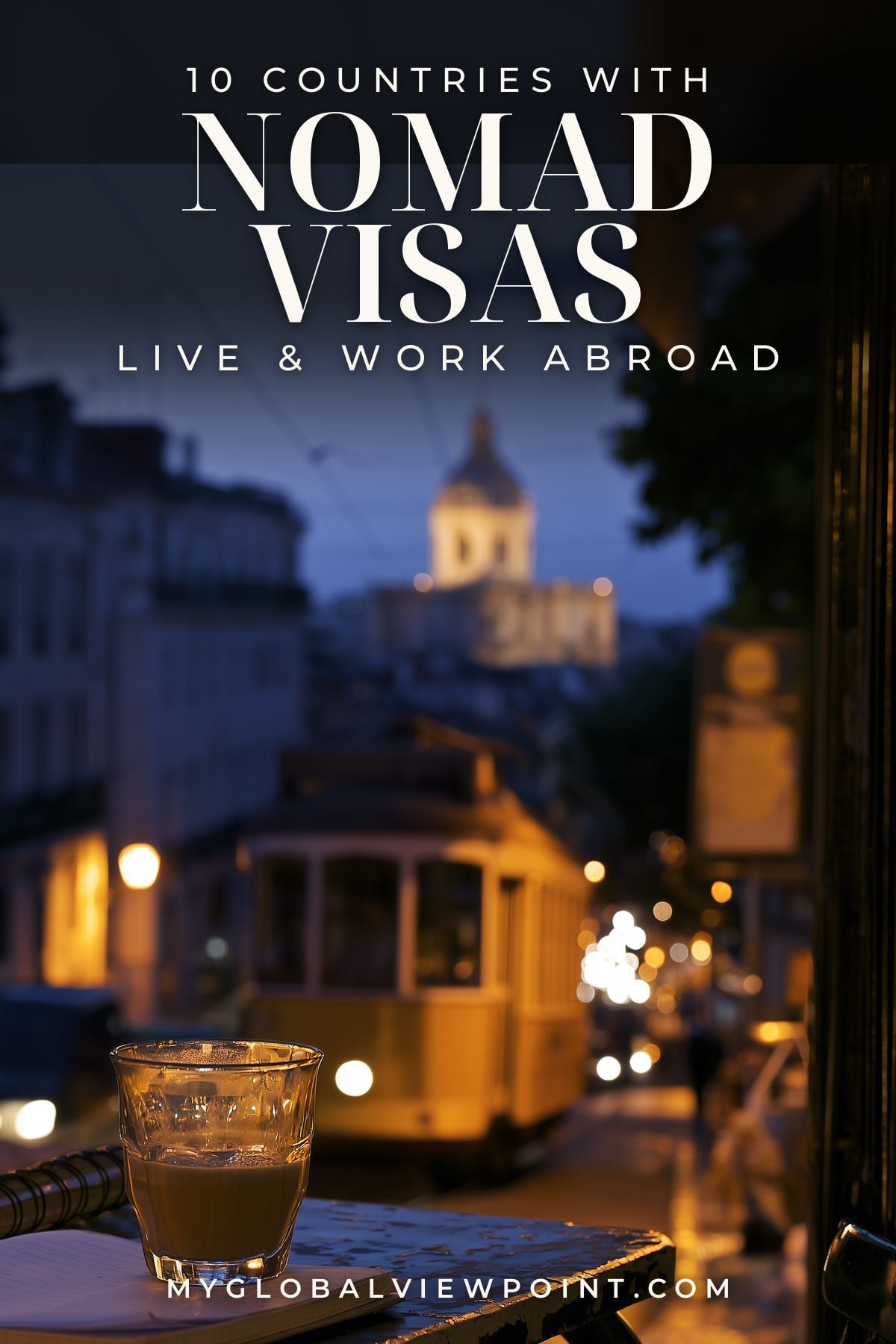 Digital nomad visa guide pin with coffee beside a Lisbon street and yellow tram at dusk.