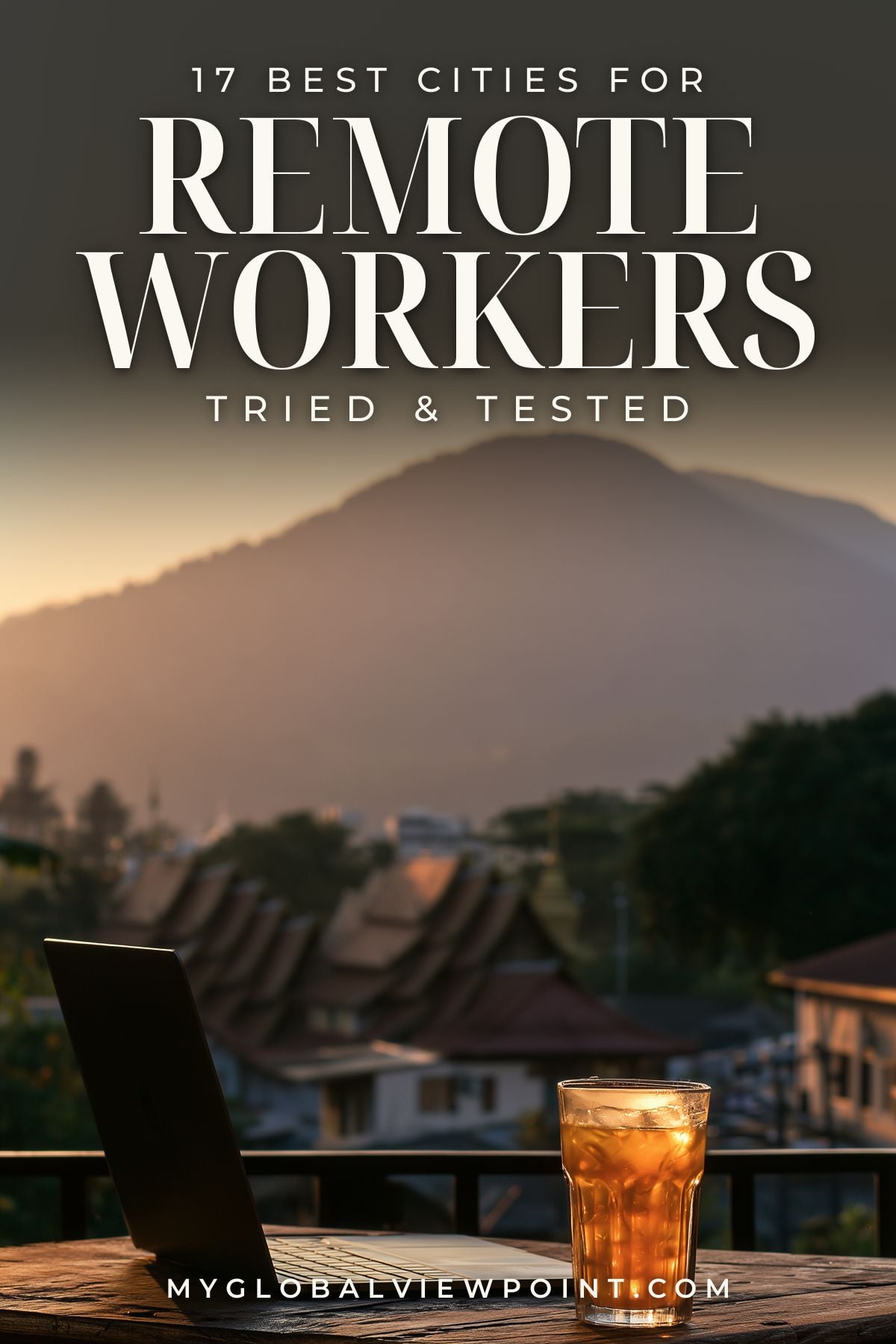 Remote work cities pin with a laptop and iced drink overlooking temple roofs and mountains.