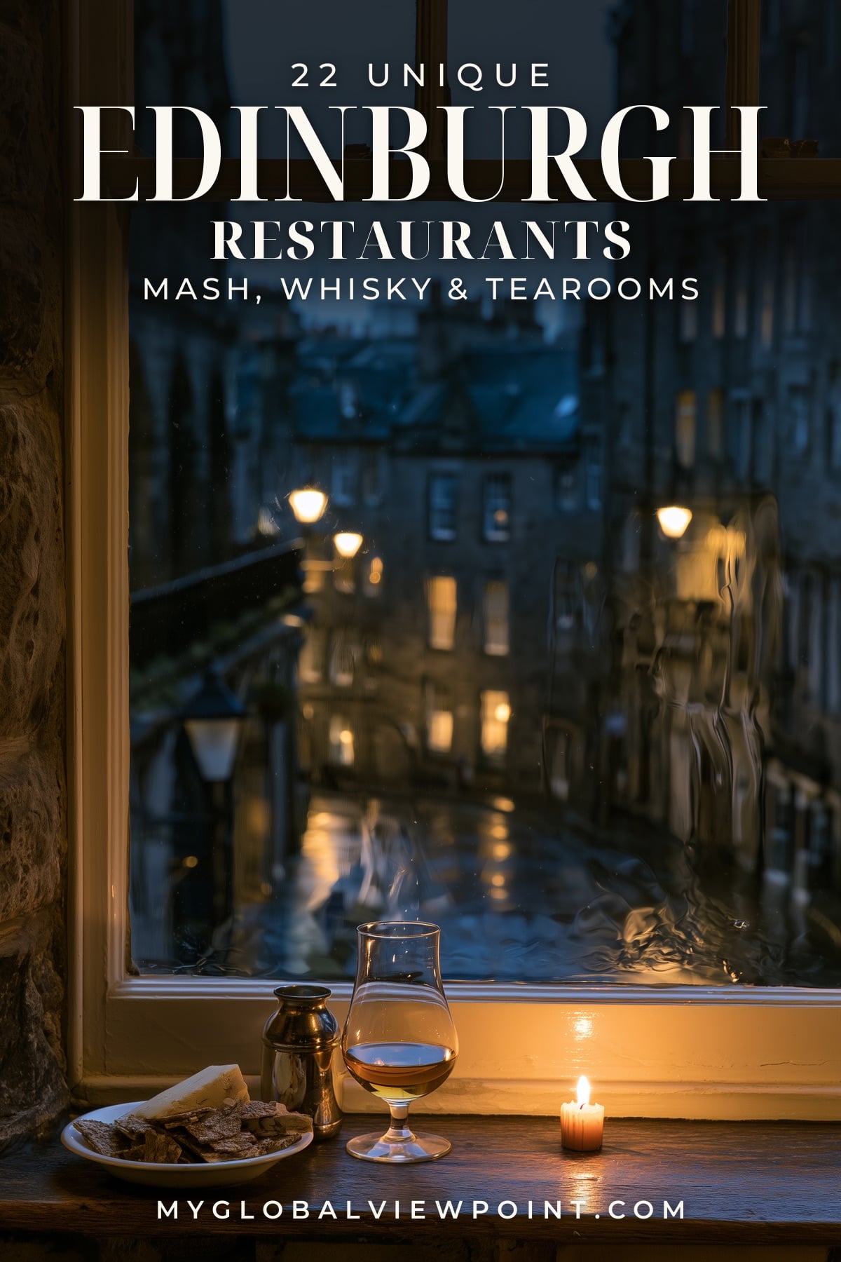 Edinburgh restaurant guide with whisky and a candle by a window overlooking a lamplit stone street at dusk.